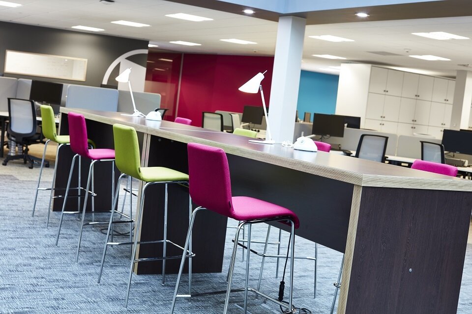Hot desks with task lighting at Qualifications Wales
